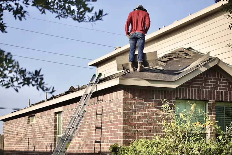Professional roofer working on a residential roof in Killinger